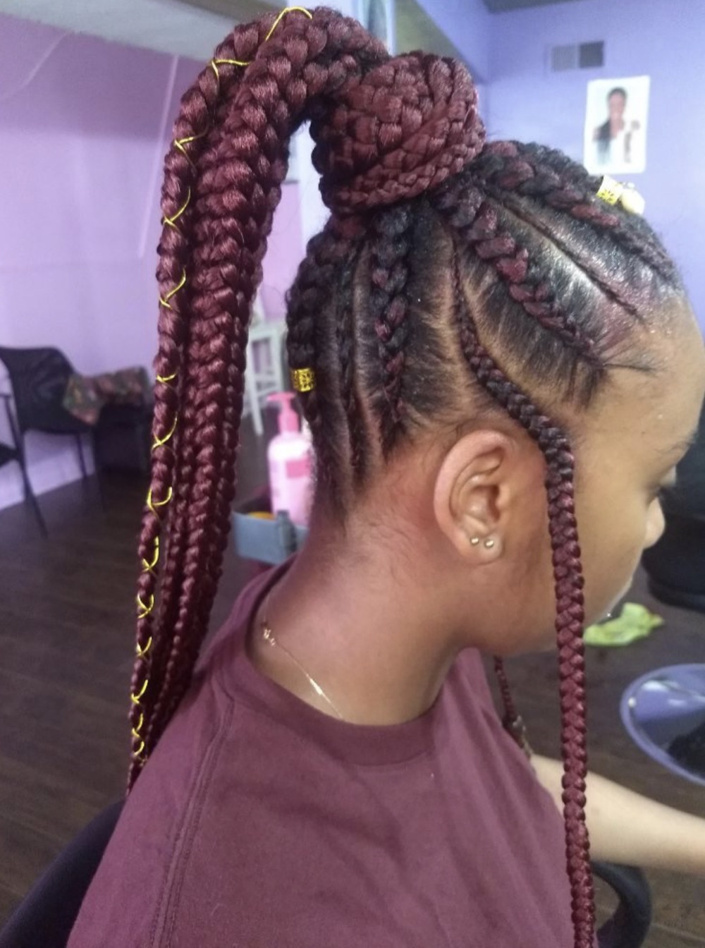 Burgundy braided ponytail with gold accents